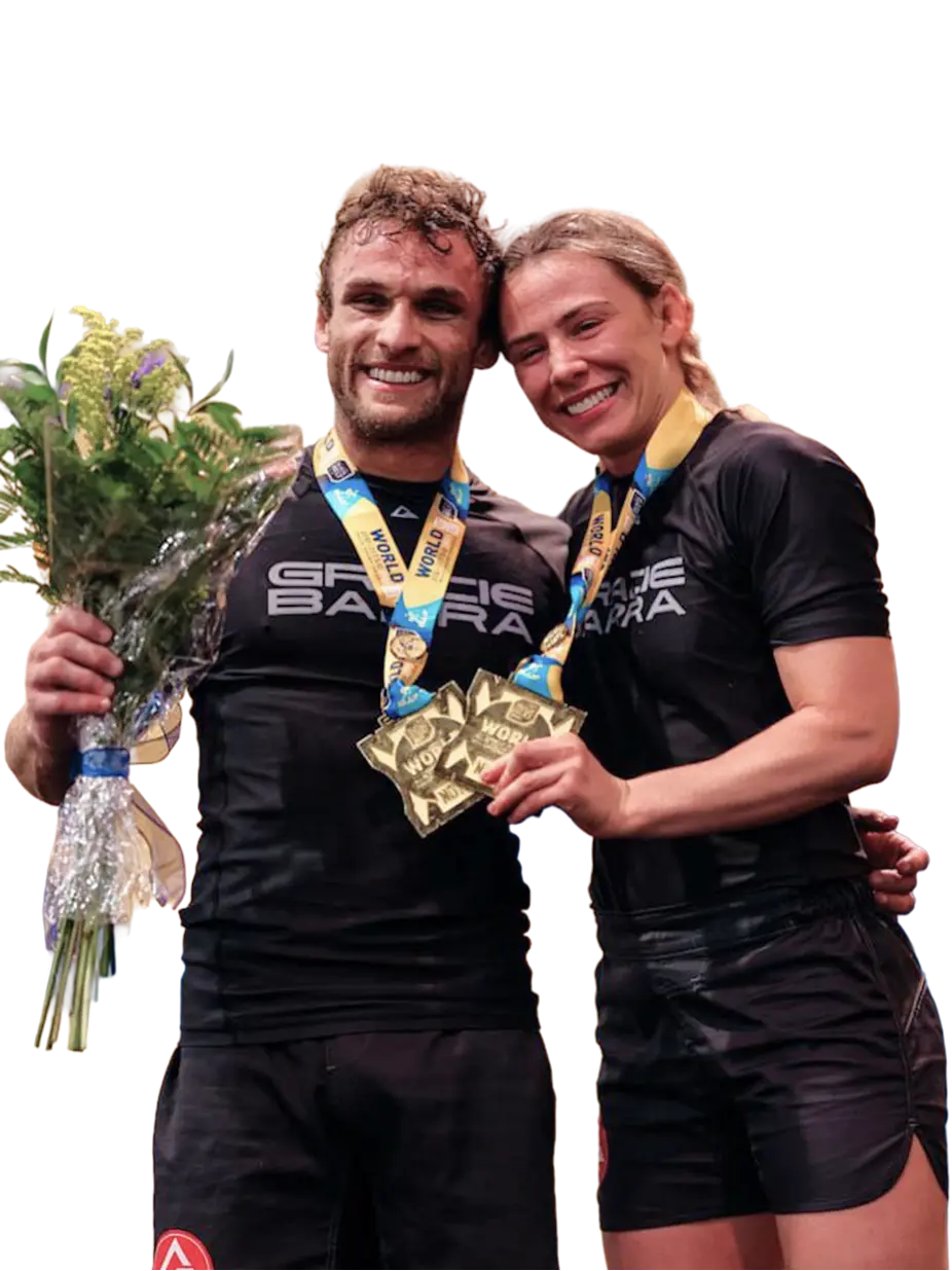 Gracie Barra instructors Lucas Valente and Andressa Cintra celebrating IBJJF World Championship titles with gold medals