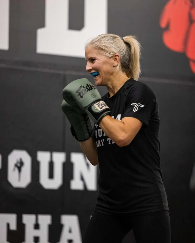 Pound 4 Pound Muay Thai class lined up with a coach in the Littleton gym