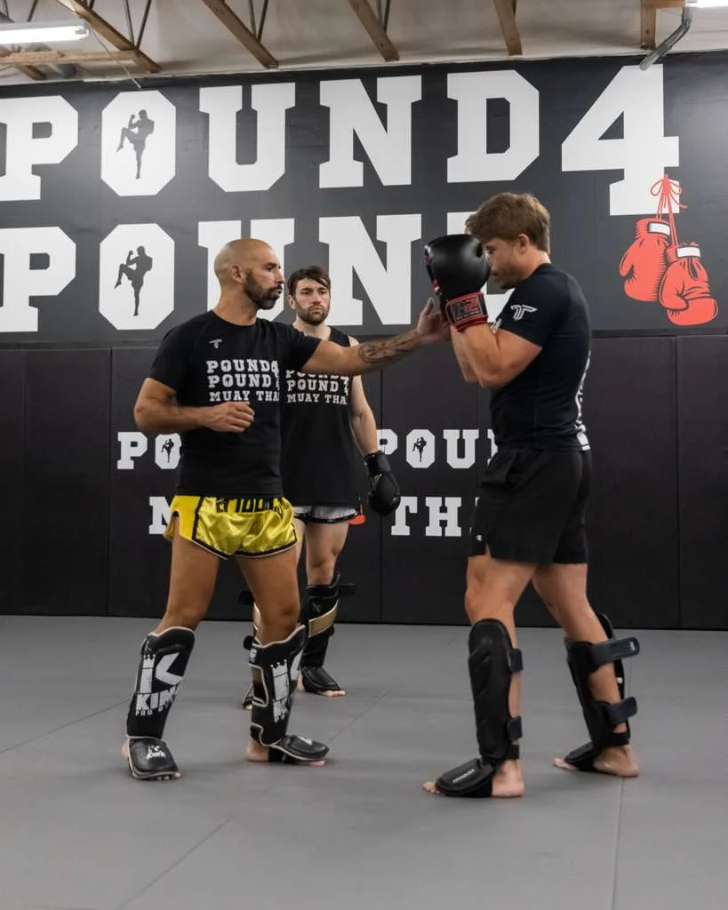 Pound 4 Pound Muay Thai teammates supporting each other during advanced training