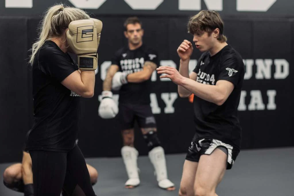 Youth Muay Thai student practicing partner drills at Pound 4 Pound in Littleton