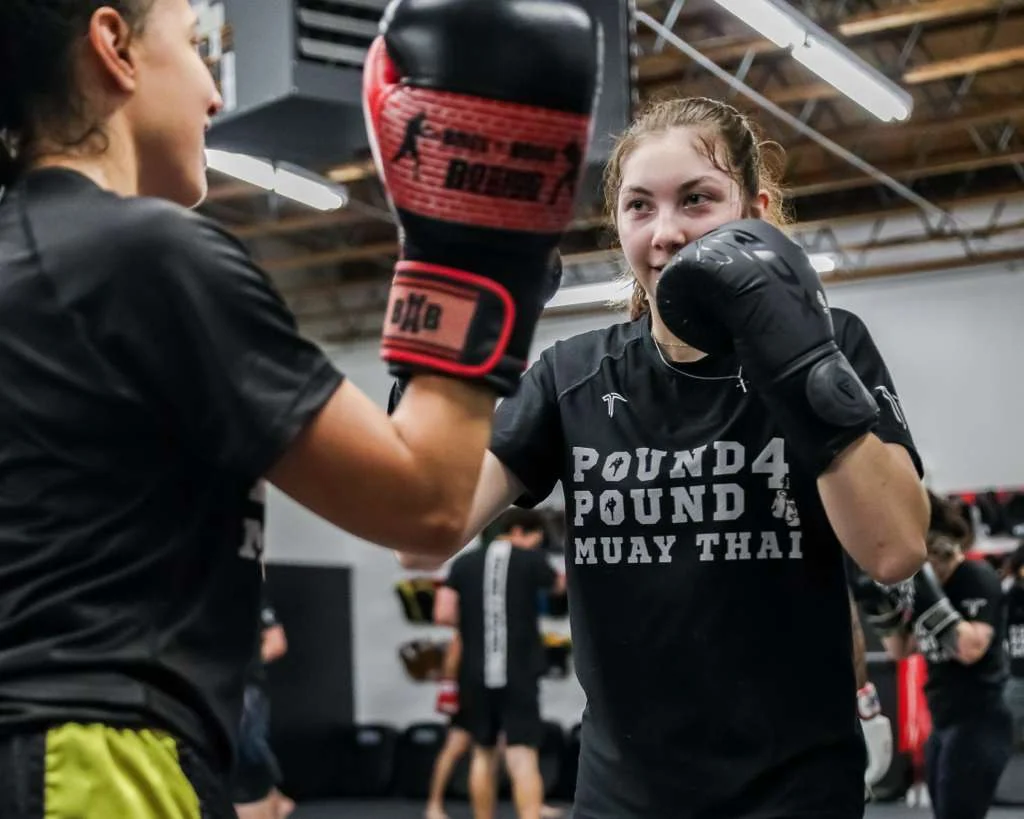 Youth Muay Thai student practicing partner drills at Pound 4 Pound in Littleton